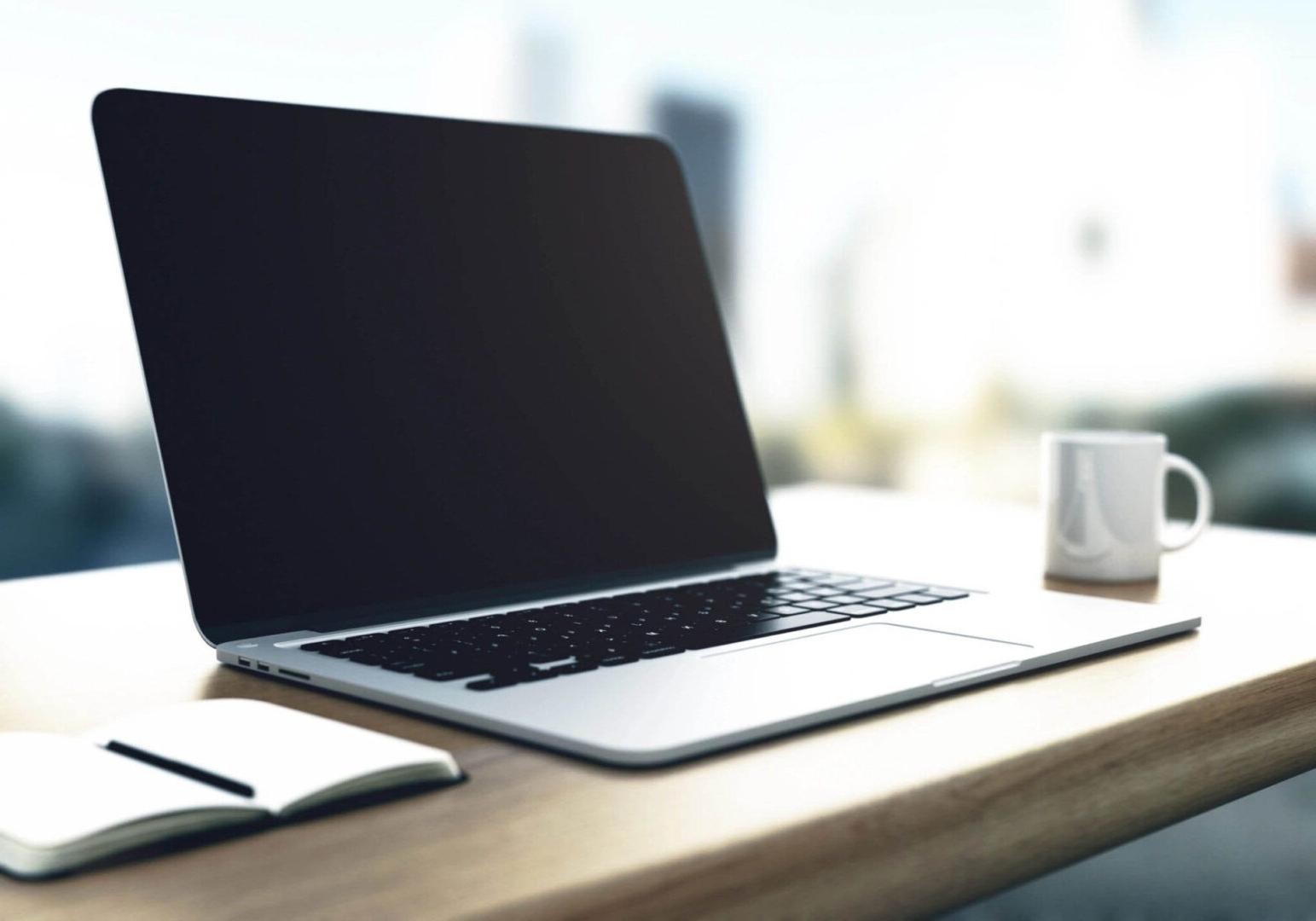 Macbook Sitting on Table with Coffee in the Background